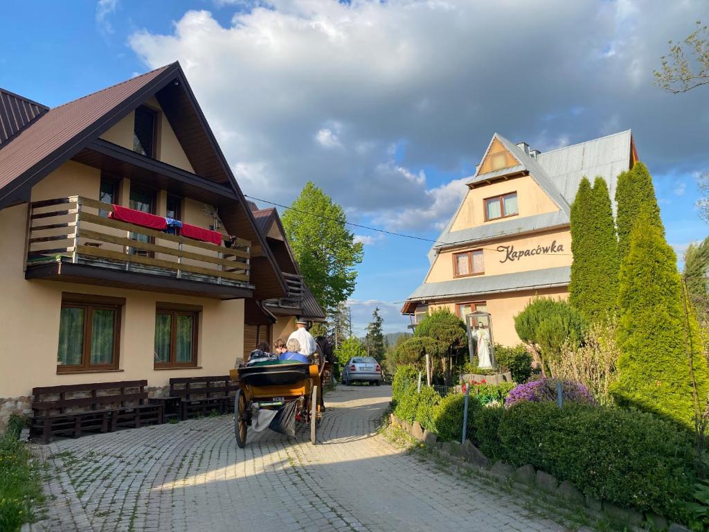 a horse drawn carriage in front of a building at Kapacówka in Zakopane