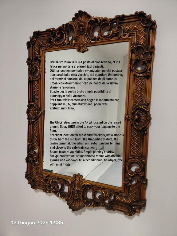 a picture of a mirror in a wooden frame at B&B Borgo Antico in Taranto