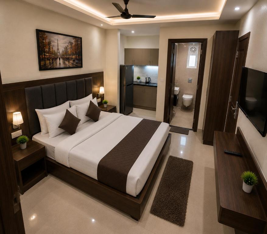 a bedroom with a large bed and a television at Sab proprty in Dānāpur