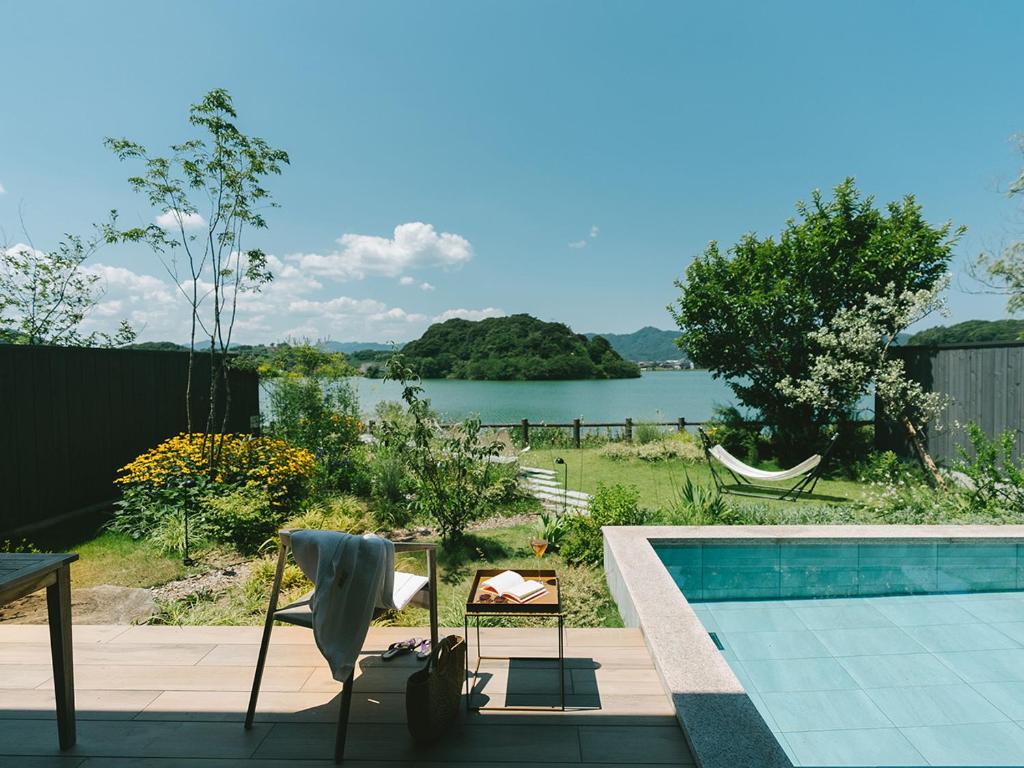 a swimming pool with a view of a body of water at HOTEL & KOTEI SOKA in Kyotango