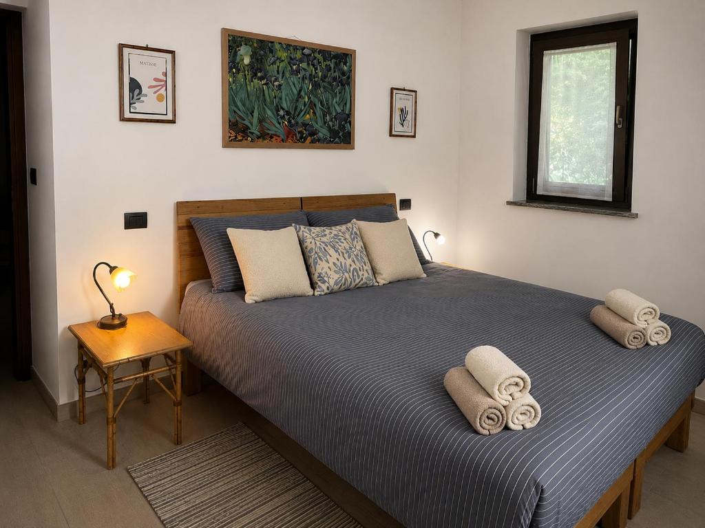 a bedroom with a bed with two pillows on it at A Casa di Laura in Parella