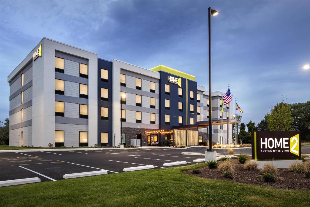 a hotel building with a sign in a parking lot at Home2 Suites By Hilton Salisbury Fruitland in Fruitland