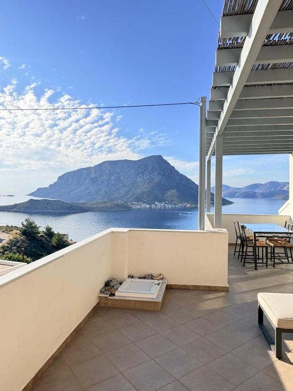 a balcony with a view of the ocean and a mountain at Sunset Vista in Kamári