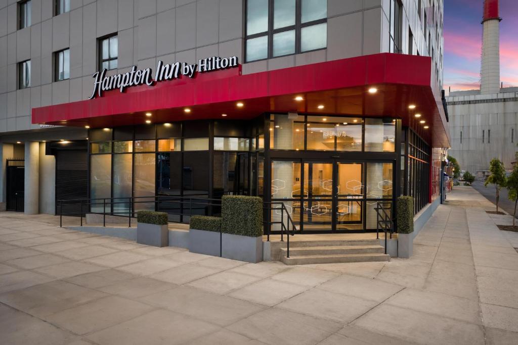 a building with a sign on the front of it at Hampton Inn Long Island City NY in Long Island City