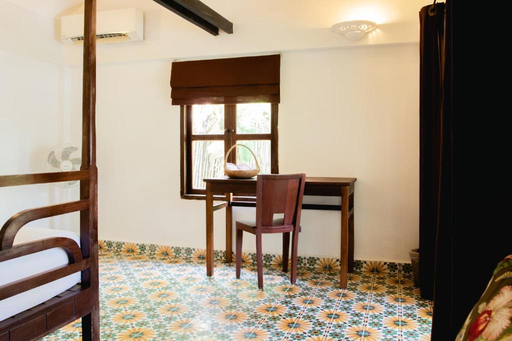 a dining room with a table and a chair at Sambor Village Hotel in Kompong Thom