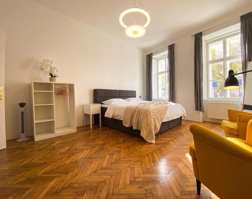 a bedroom with a bed and a wooden floor at Villa Jahn in Baden