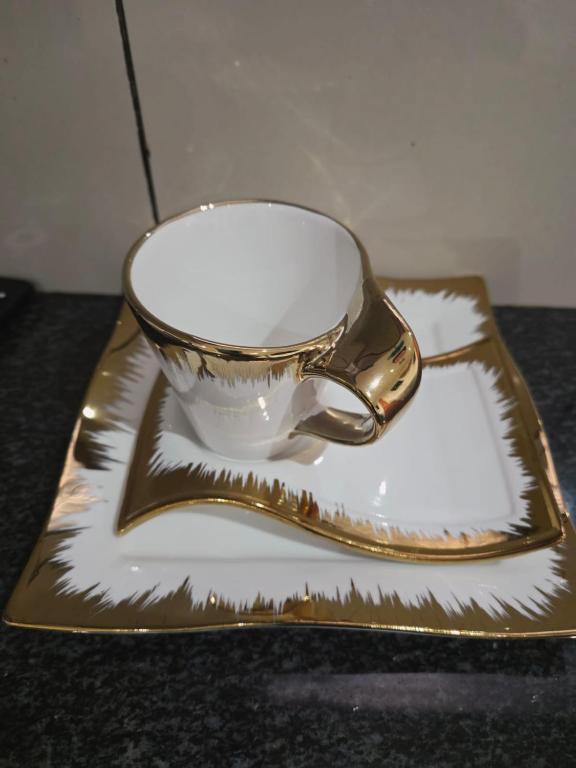 a tea cup on a plate on a table at Mafjoint5 in eMalahleni