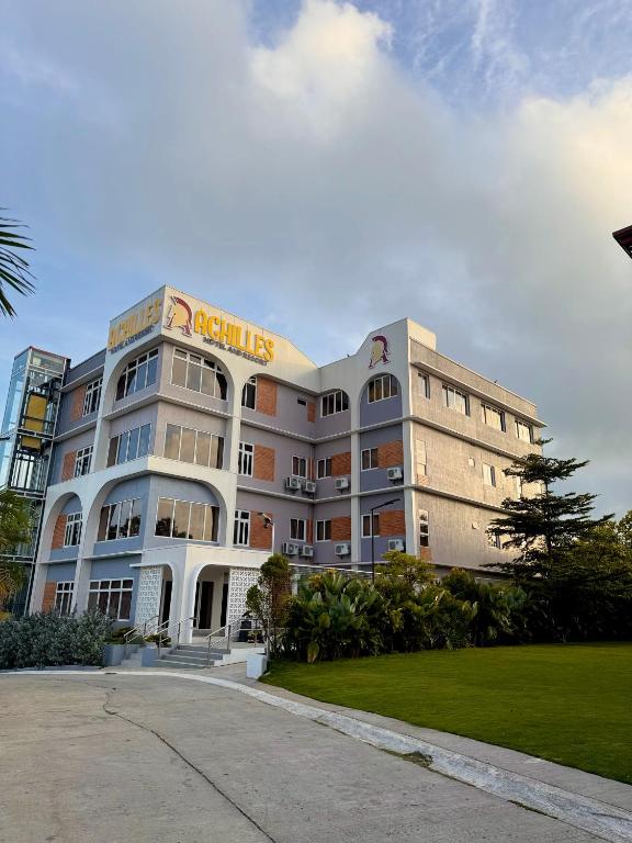 a building with a sign on the side of it at Achilles Hotel in Maitim