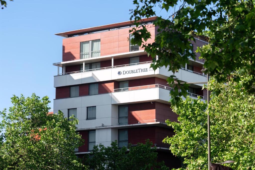 an apartment building with a sign that reads dortmund at DoubleTree by Hilton Paris Boulogne in Boulogne-Billancourt