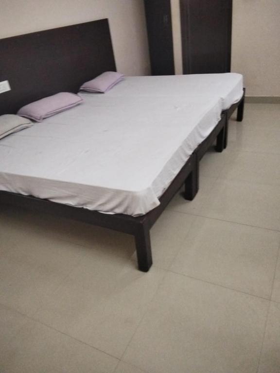 a bed with two pillows on it in a room at Royal Residency in Gingee