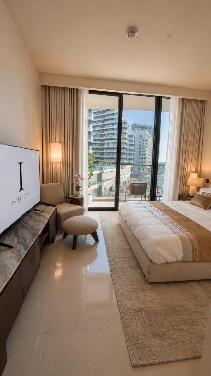 a bedroom with a large bed and a large window at Inter Home Coral - beach access in Ras al Khaimah