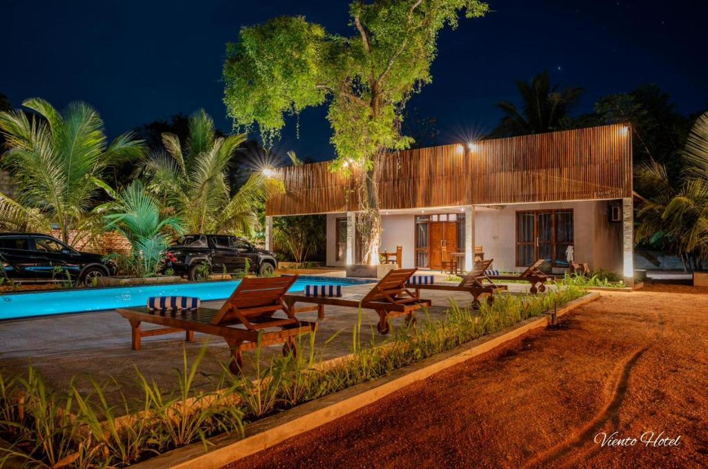 a house with a swimming pool at night at Viento - Habarana in Habarana
