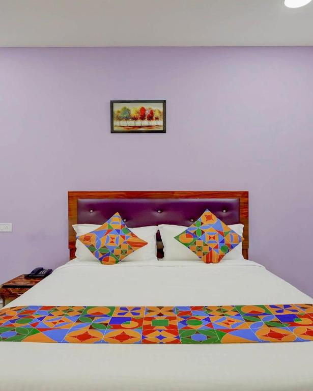 a bedroom with a bed with a colorful comforter at Embassy Gate Residency - opp US Embassy in Chennai