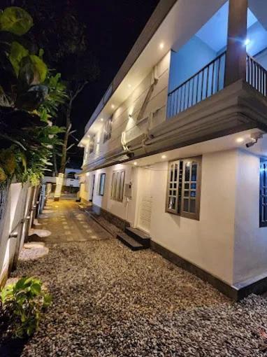 a building with a walkway next to a building at Seabay Bliss Varkala by Ojes in Varkala