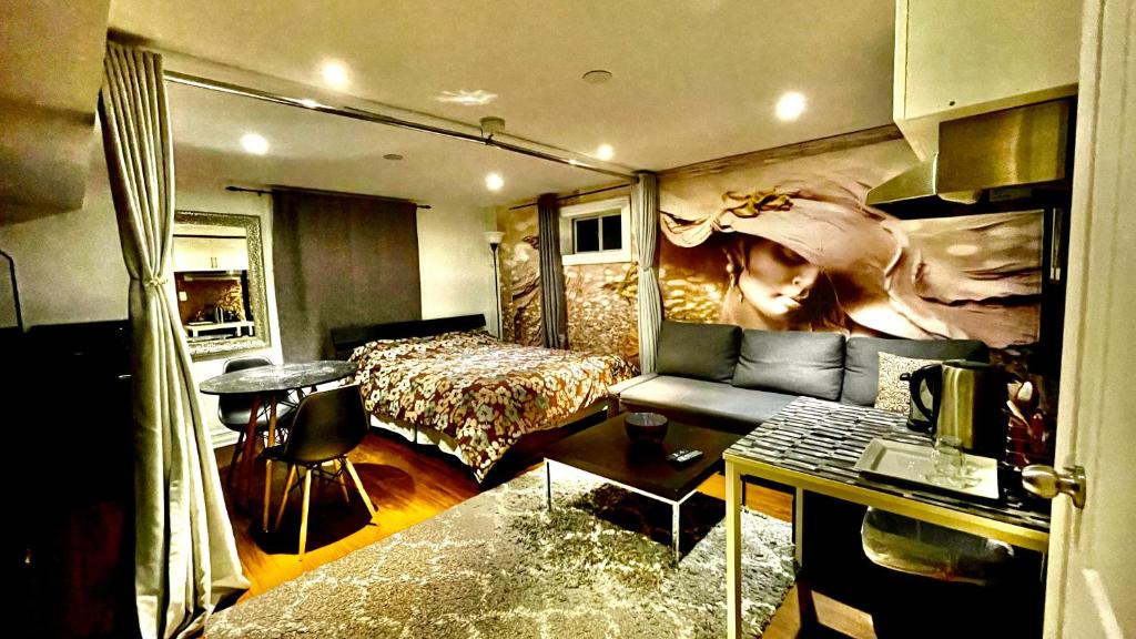 a hotel room with a bedroom with a bed and a table at Luxury KIA Room K in Richmond Hill
