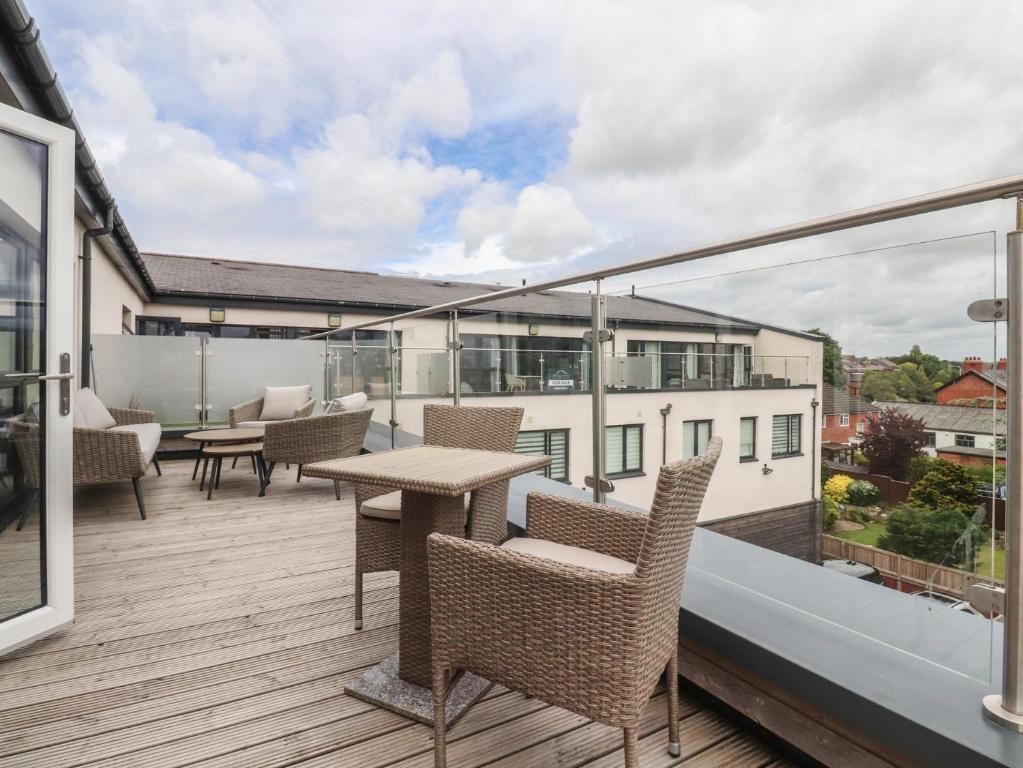 a balcony with chairs and tables on a building at Apartment 20, River View in Preston