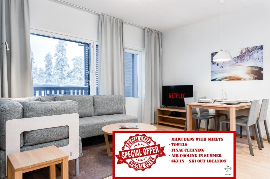 a living room with a couch and a table at RukaHillChalet4 Ski In - Ski Out in Ruka