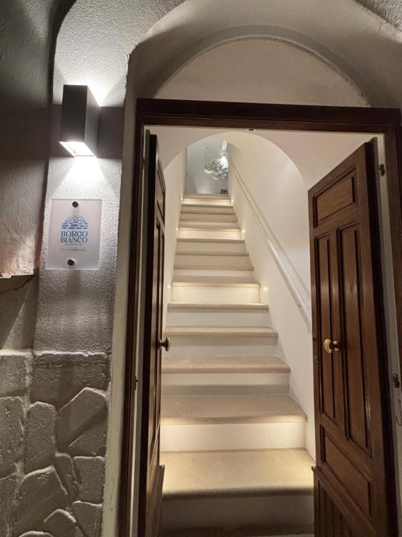 a staircase in a building with a door and a stair case at Borgo Bianco in Vieste