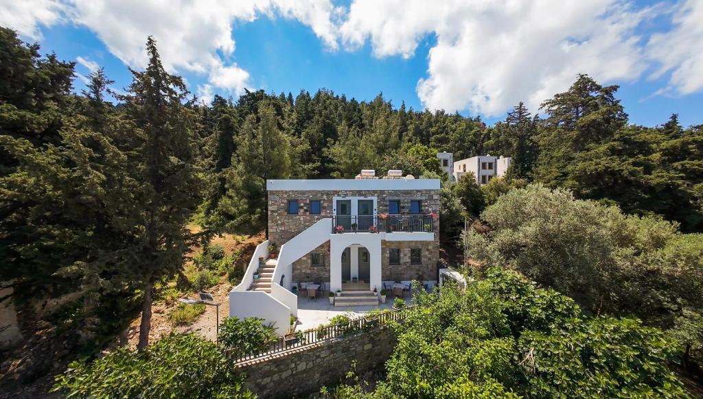 an aerial view of a house with trees at sunny rock 2 apartments in Lagoúdi Zía