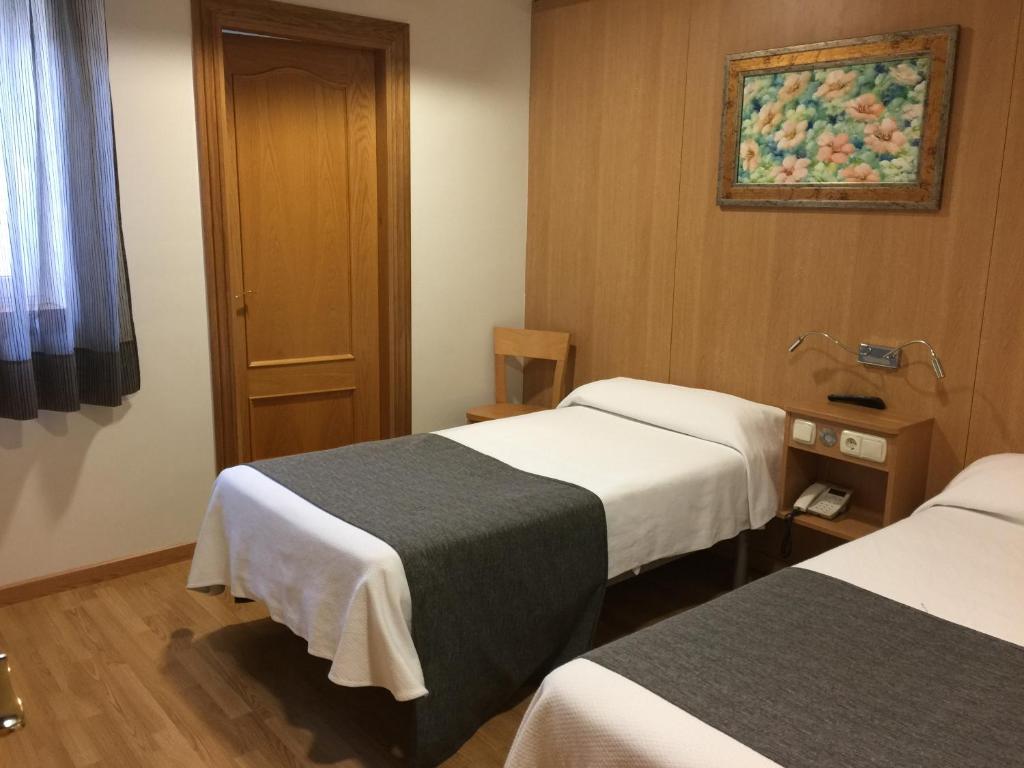 Postel nebo postele na pokoji v ubytování Iraipe Izaga Hostal