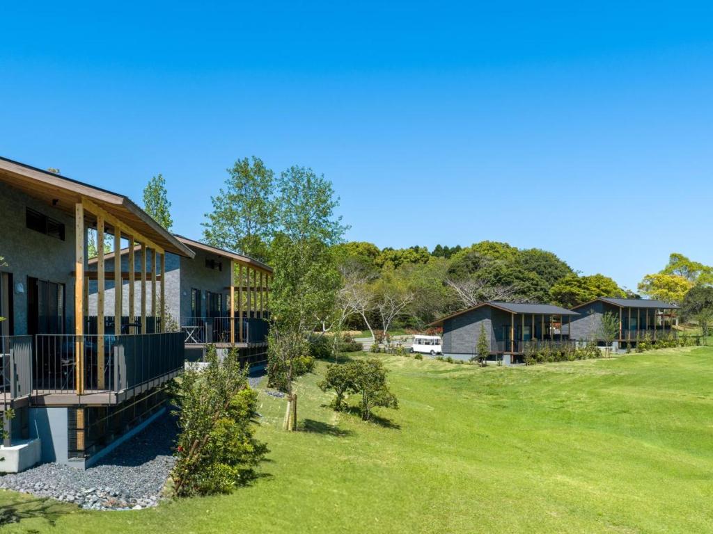 a row of houses with a green yard at Nemu Resort Hotel Nemu in Shima