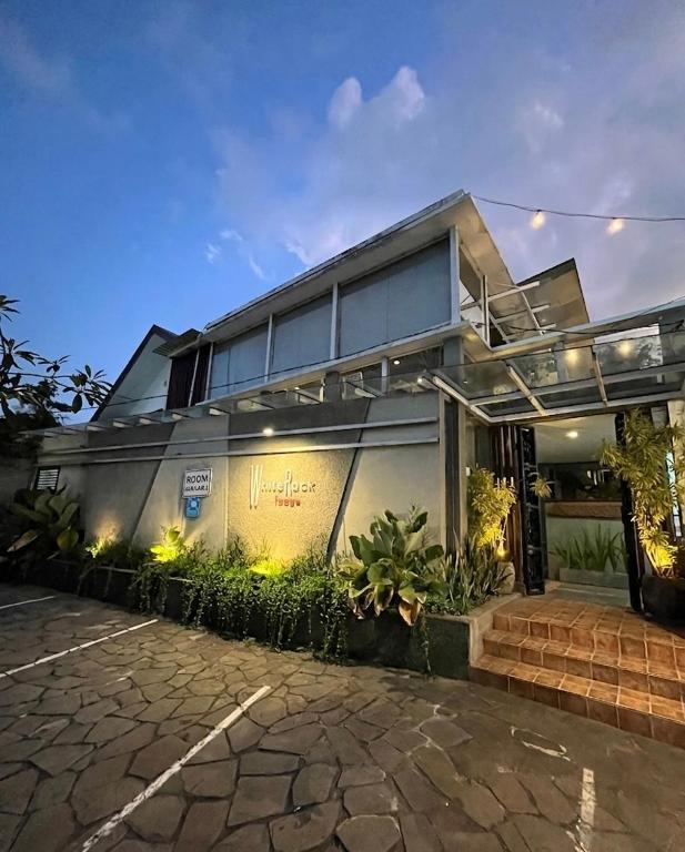 a large house with lights on the side of it at White Rock Lodge in Nusa Dua