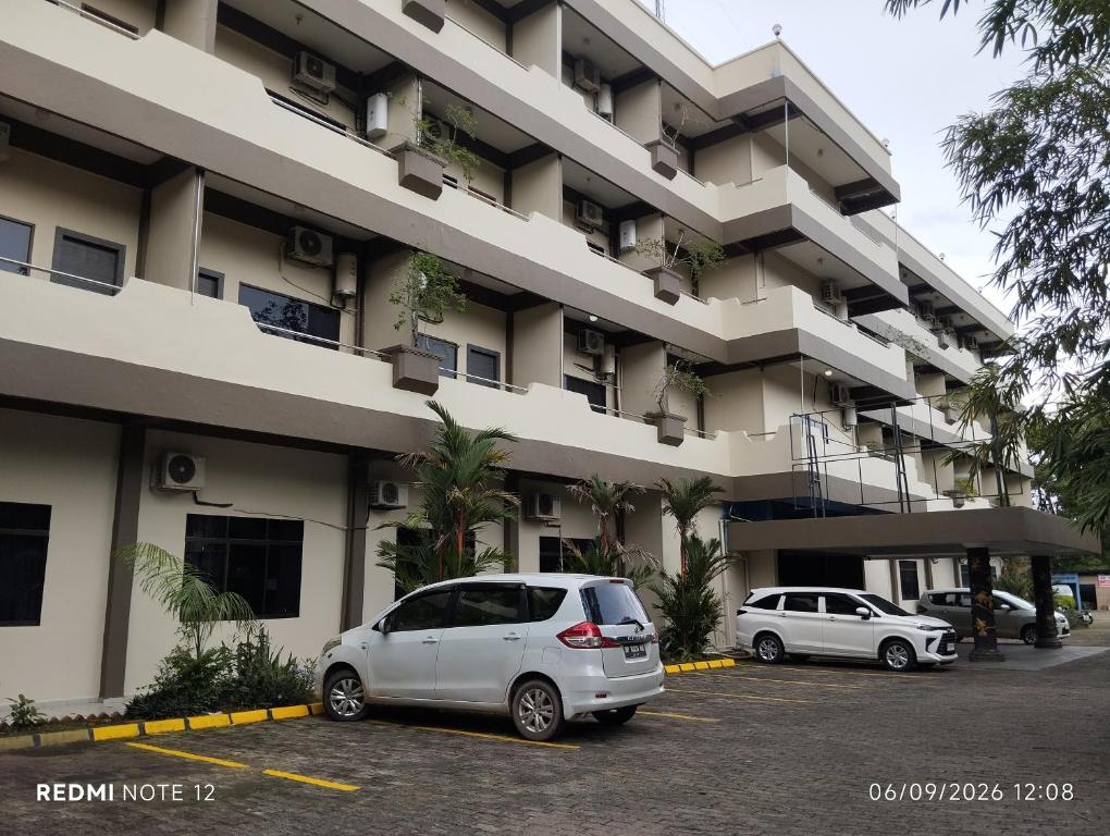 a white van parked in front of a building at Pelangi Hotel & Resort in Tanjung Pinang