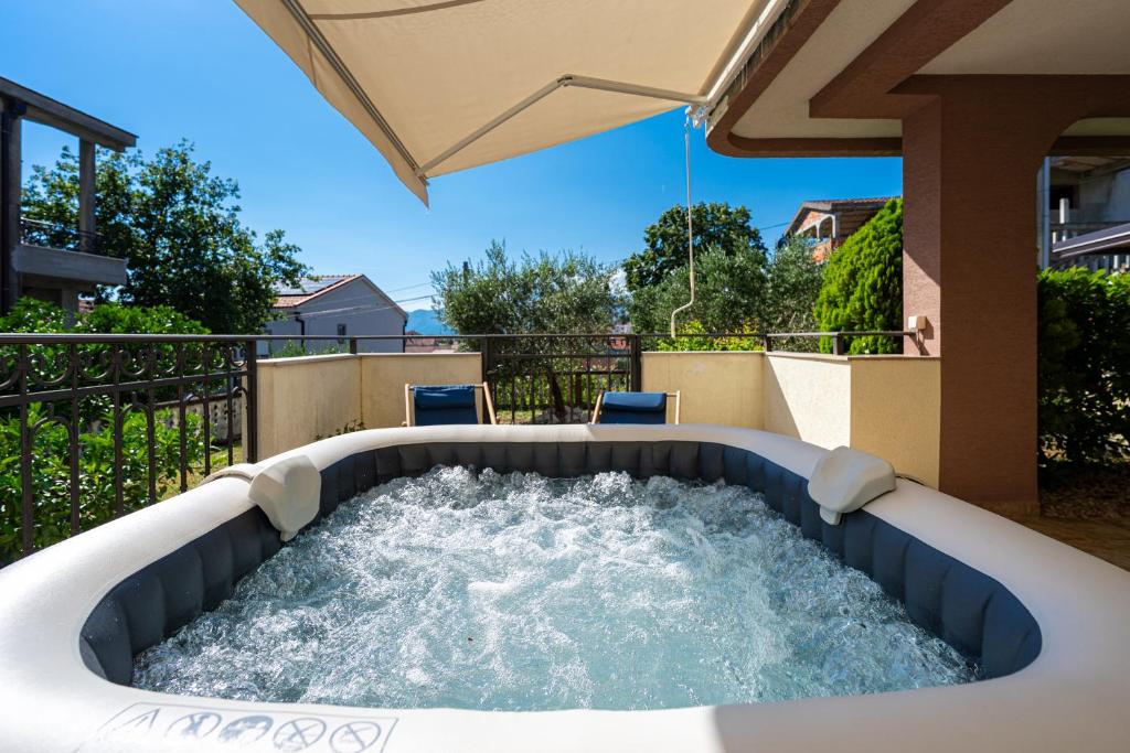 a hot tub with water in a backyard at Villa Dorotea in Tivat