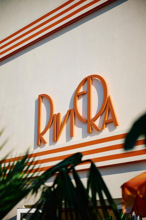 a sign on the side of a building with a ryan sign at Riviera Hotel Menorca in Ciutadella