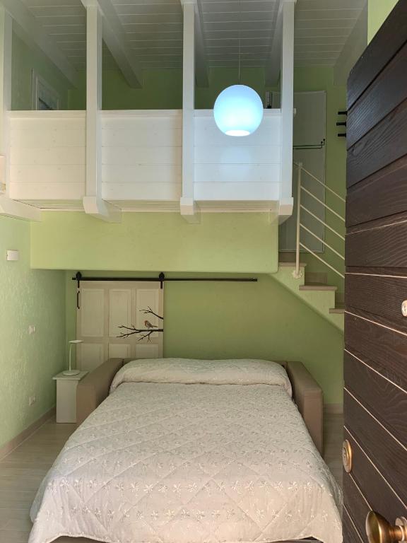 a bedroom with a bed in a green room at B&B Verde Pastello in Pianopoli
