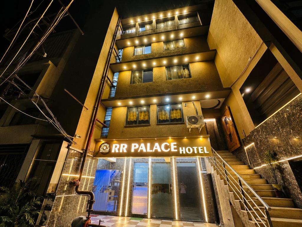an entrance to an rr palace hotel at night at Hotel RR Palace in Rajkot