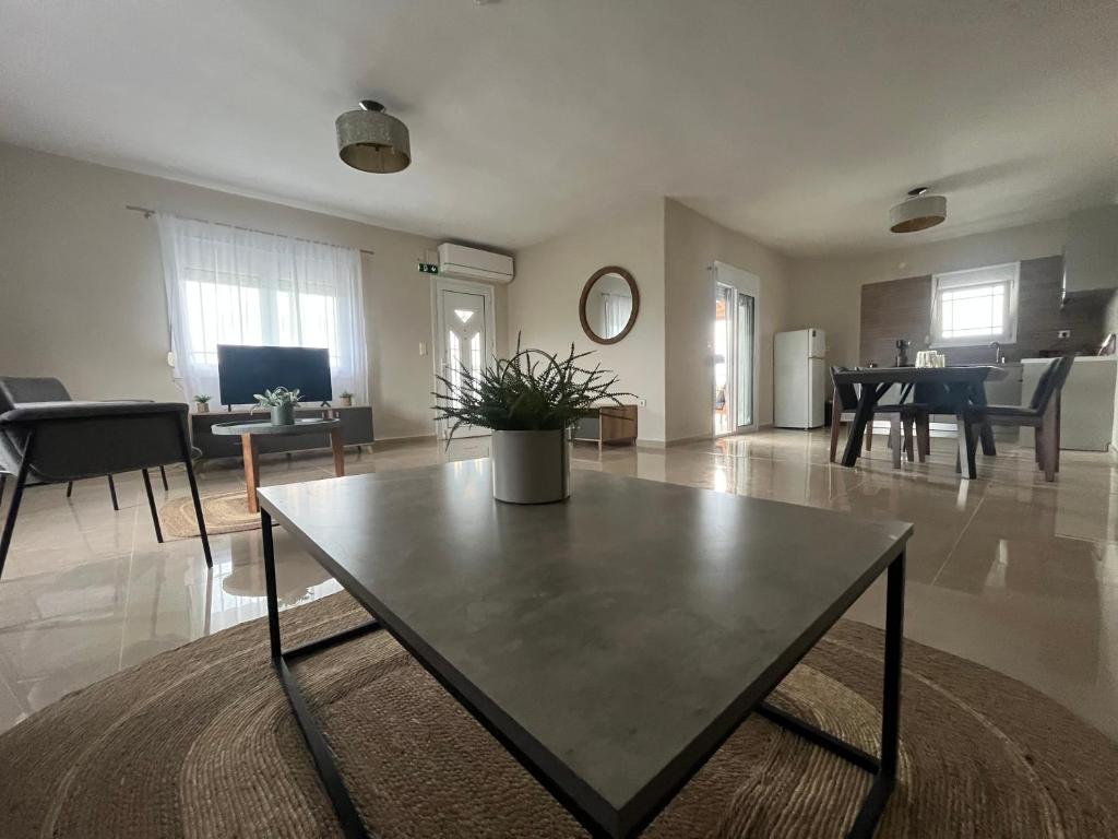 a living room with a table in the middle at Sky Apartment in Ofrínion