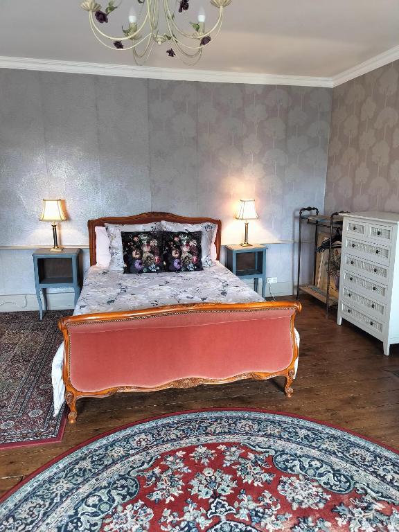 a bedroom with a bed with two tables and two lamps at Fleur de Lys - Free wi-fi & parking in La Haye