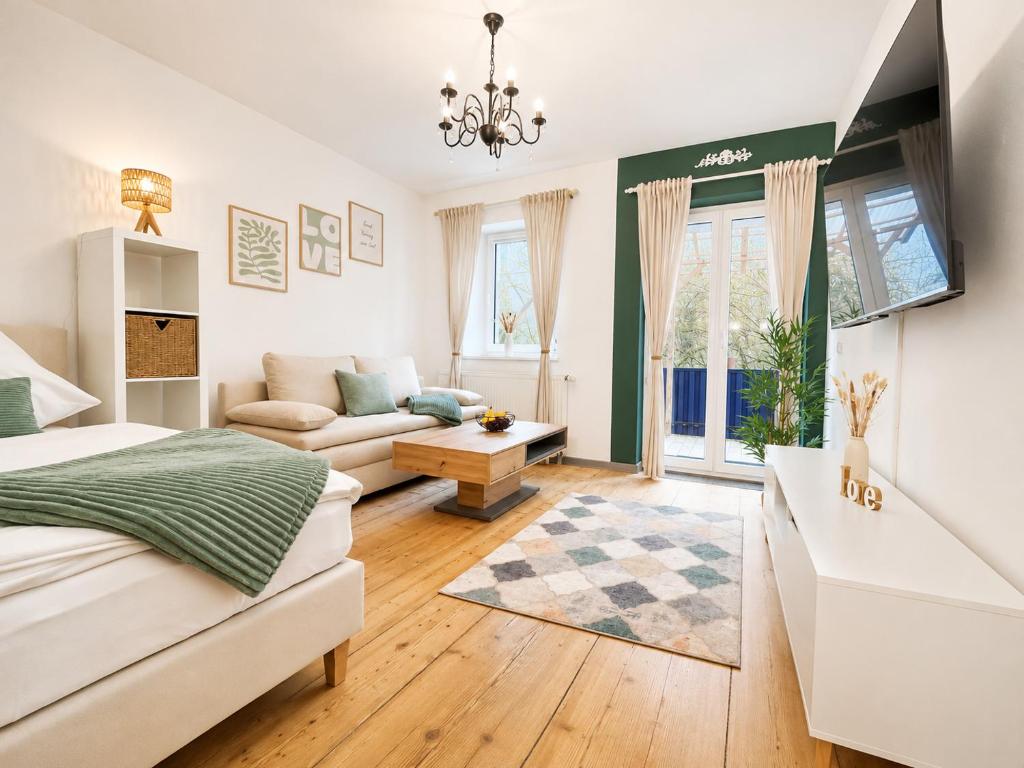 a bedroom with a bed and a living room at 'GoldPath' OldTown - Apartments Passau in Passau