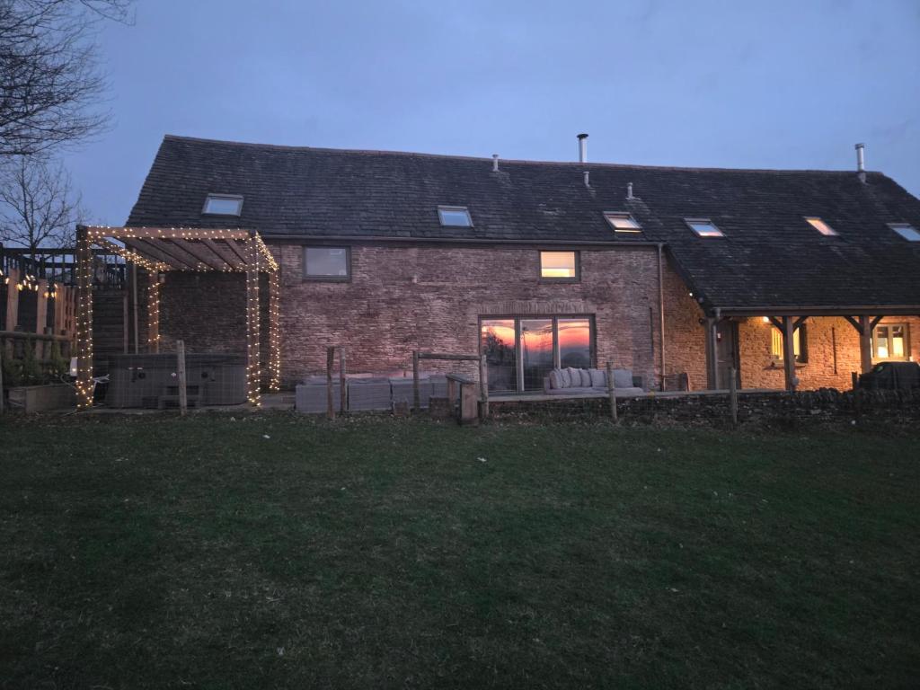 a brick house with a large window on the side of it at The Barn in Crumlin