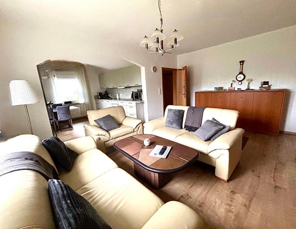 a living room with two couches and a table at Ferienwohnung Schöne Aussicht in Nieheim