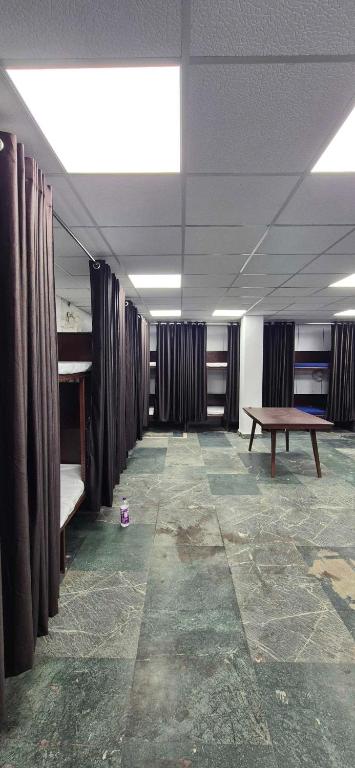 an empty room with a bench and a table at Chandra Dormitory in Varanasi