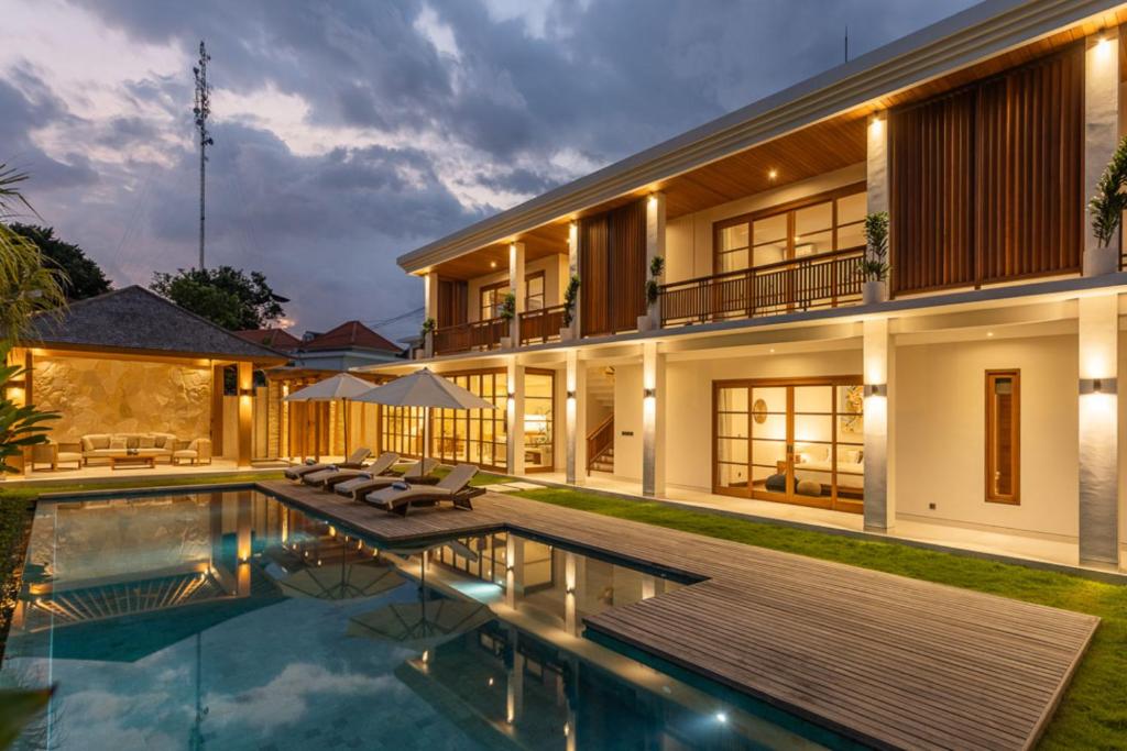 an exterior view of a house with a swimming pool at Villa Pura Bali in Canggu