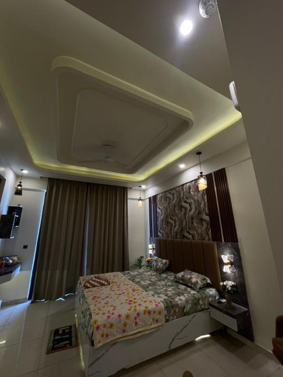 a bedroom with a bed and a painting on the wall at Tehzeeb living in Lucknow