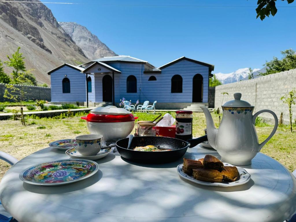 a table with plates of food and a tea pot at Valley View Homestay in Bīrgal