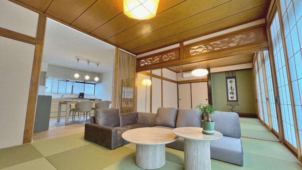 a living room with a couch and a table at Tabinoteitaku 和-WA- in Sendai