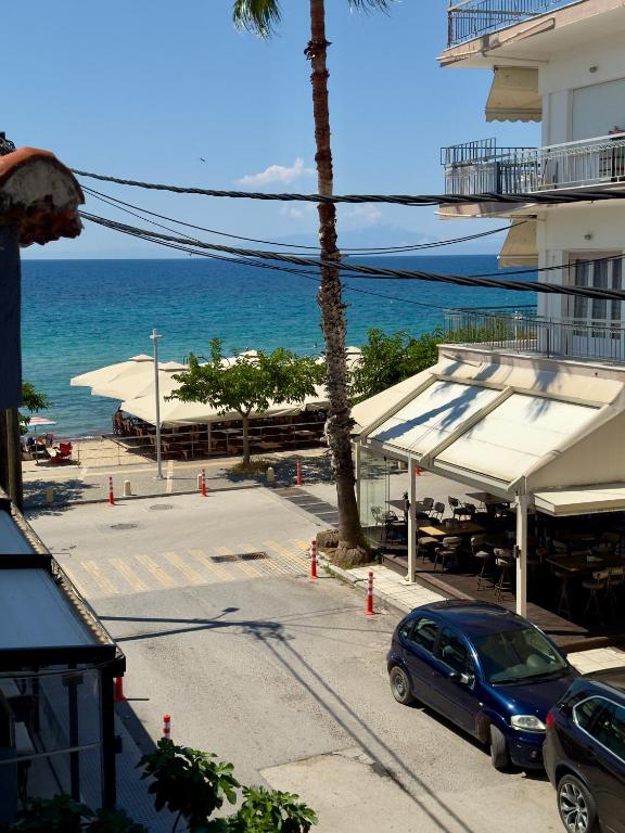 a car parked in a parking lot next to the ocean at Coral Blue By Infinity in Nea Kallikrateia