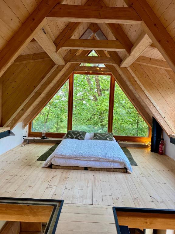 a bed in a room with a large window at Studio MEZILES in Buš