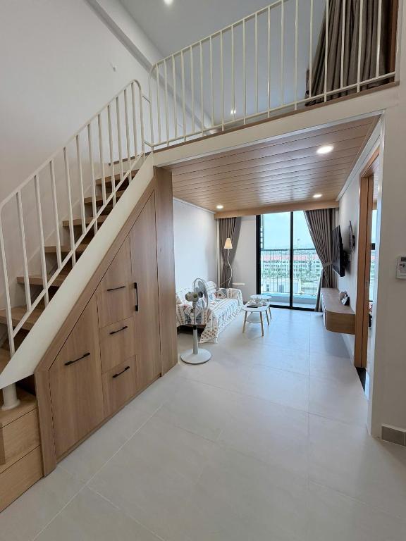 a hallway with a staircase and a living room at Ong Vàng in Quang Ãm