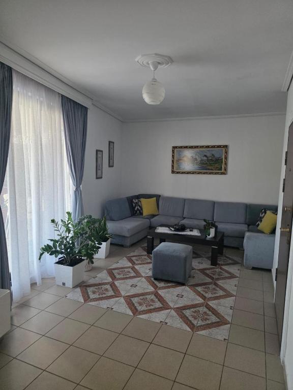 a living room with a couch and a table at Comfort Saranda Apartment in Sarandë