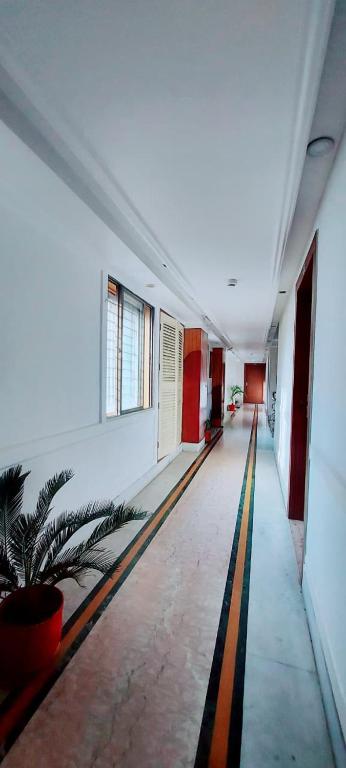 an empty hallway of a building with a yellow stripe on the floor at Hotel Rodali Residency in Guwahati