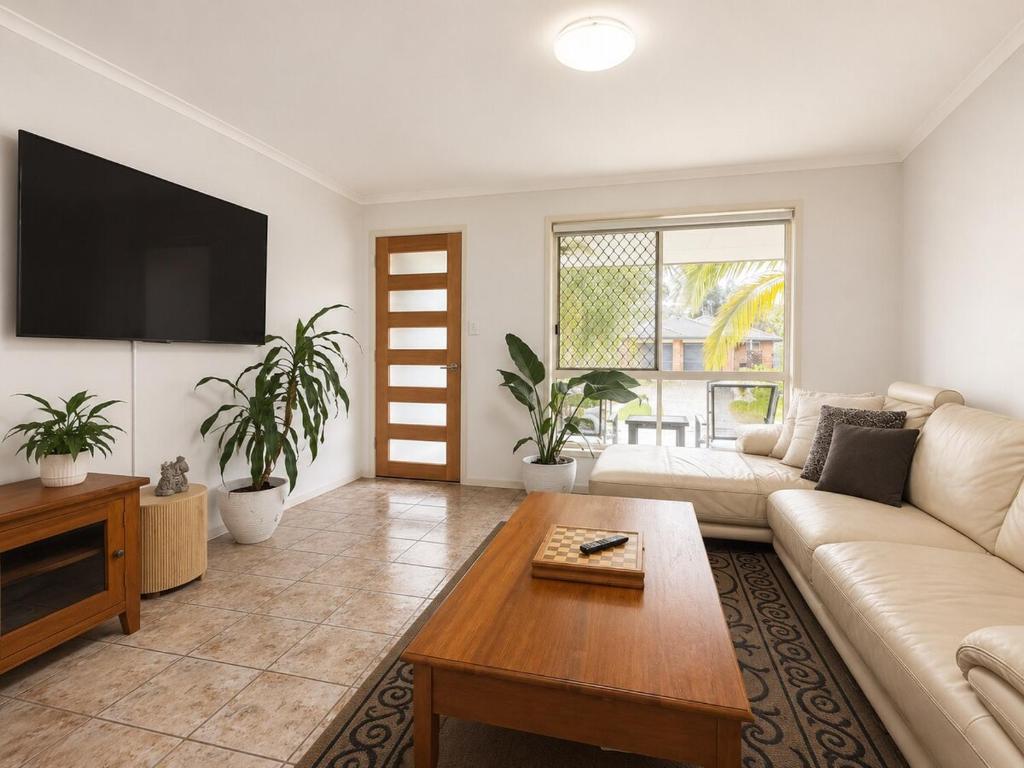 a living room with a couch and a table at Pet Friendly close to Mooloolaba Sleeps 6 in Mountain Creek