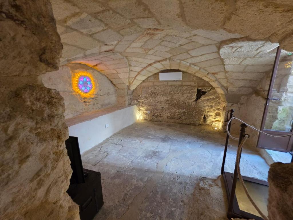 a room with a camera in a stone building at Dimora Pietra E Luce By Cala Salento in Vignacastrisi