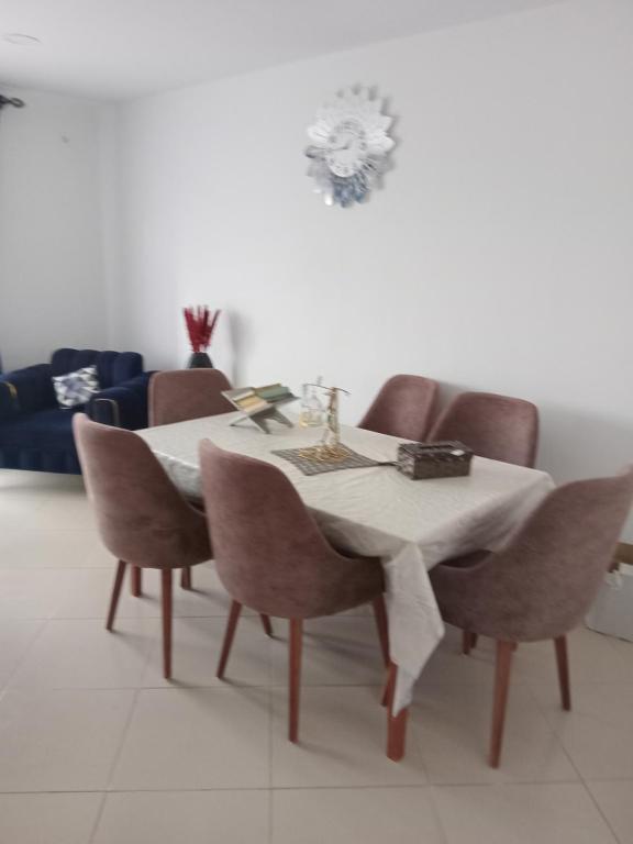 a dining room table with chairs and a white table cloth at Oran ville in Oran