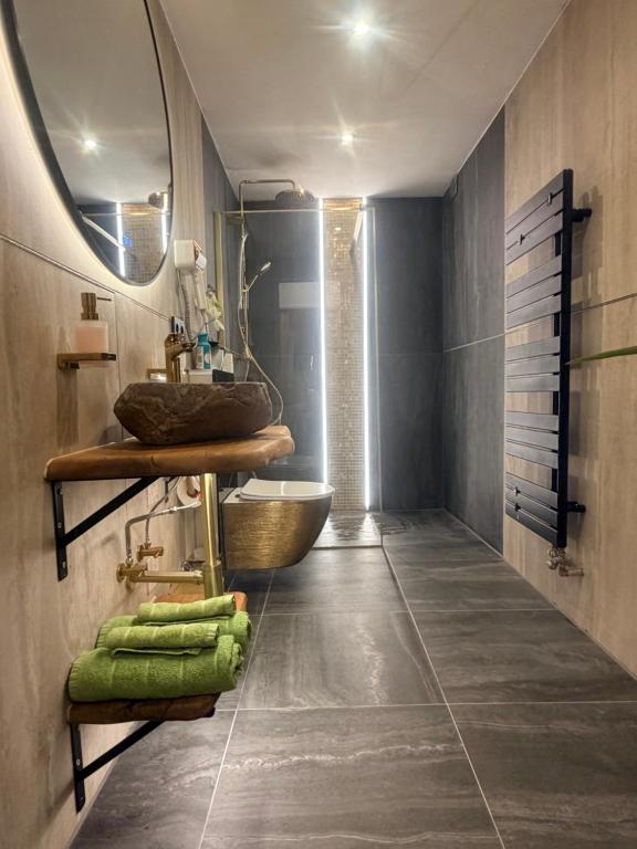 a bathroom with a sink and a mirror at Emerald Alpine Apartment Seefeld in Seefeld in Tirol